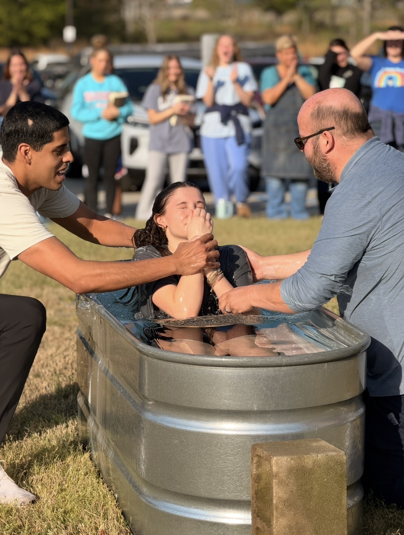 Student being baptized at Lions' Den