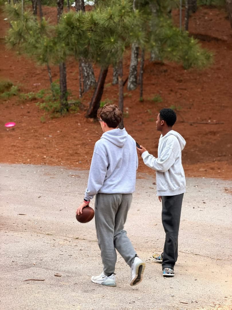 Students playing football outside
