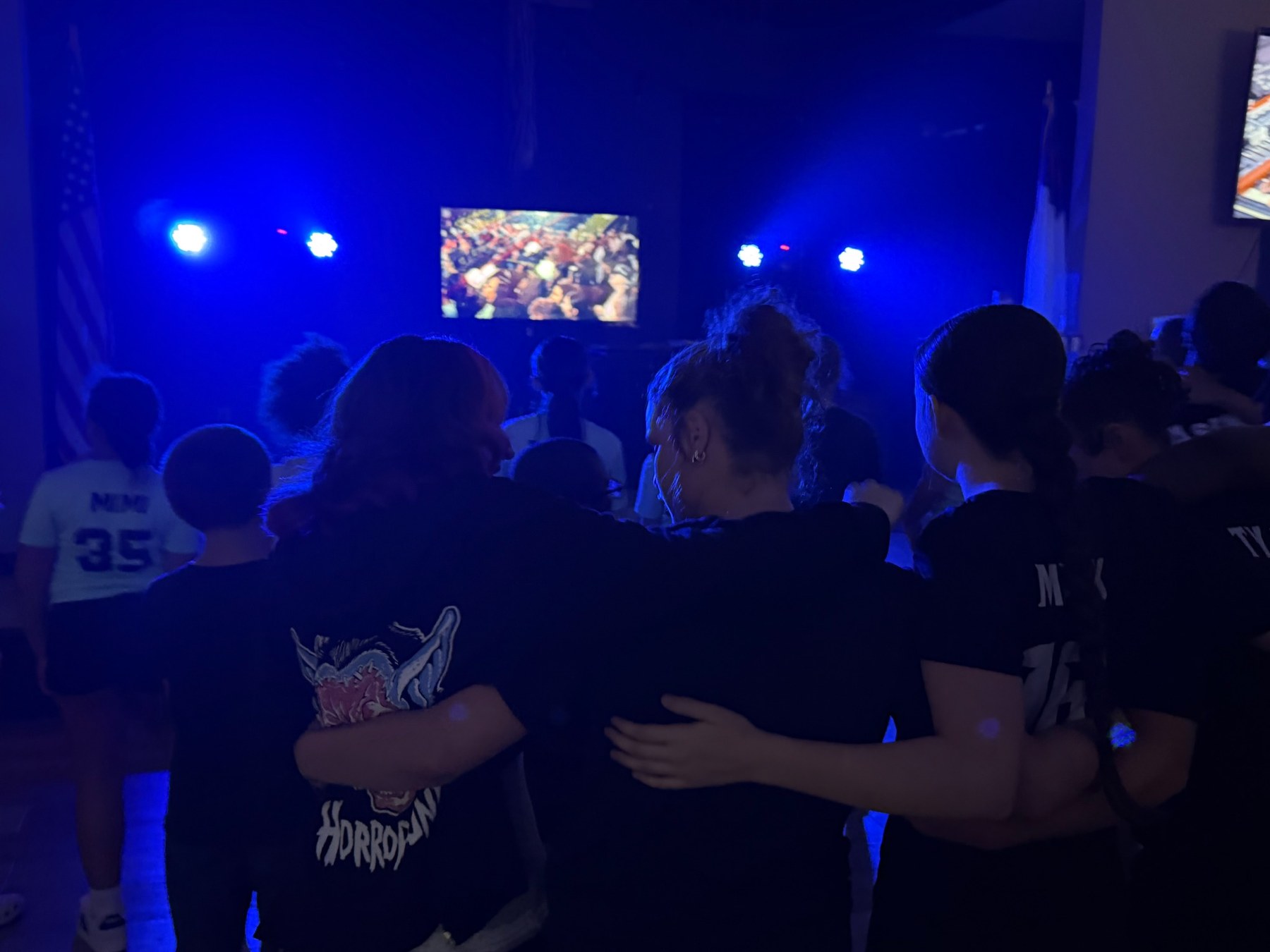 Students worshiping in blue lights