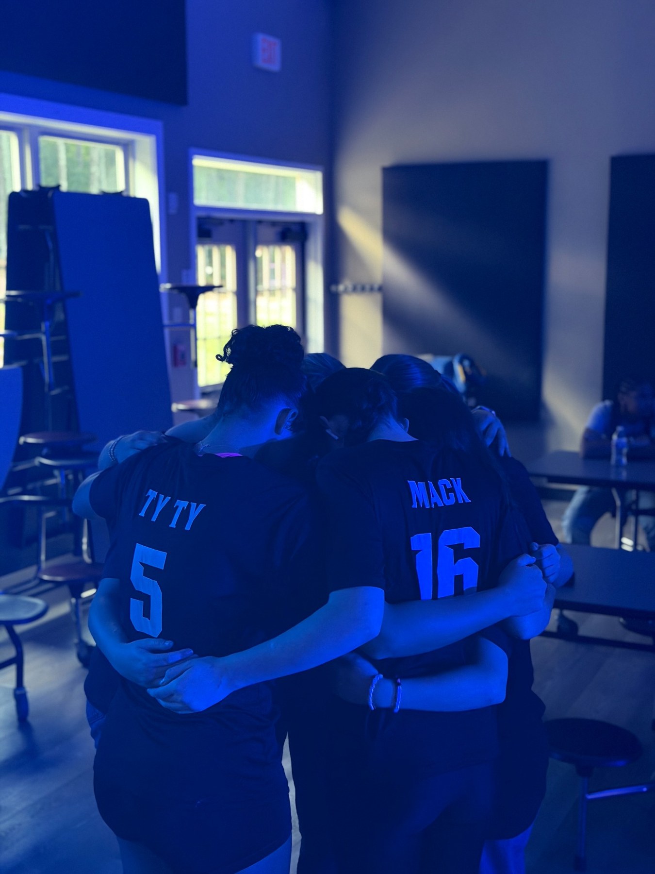 Students praying together at Lions Den