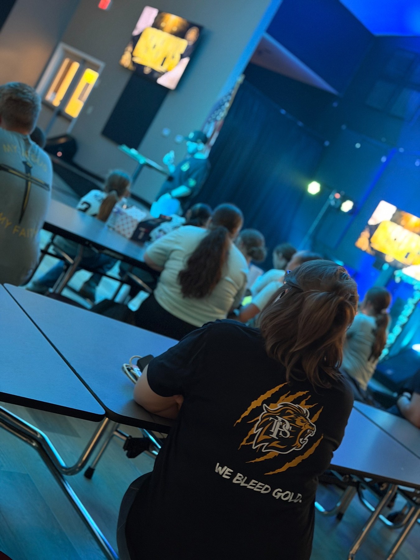 Students listening at Lions Den